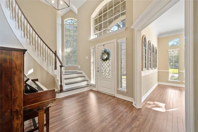 a view of an entryway with wooden floor and door