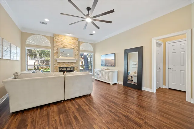 a living room with furniture and large windows