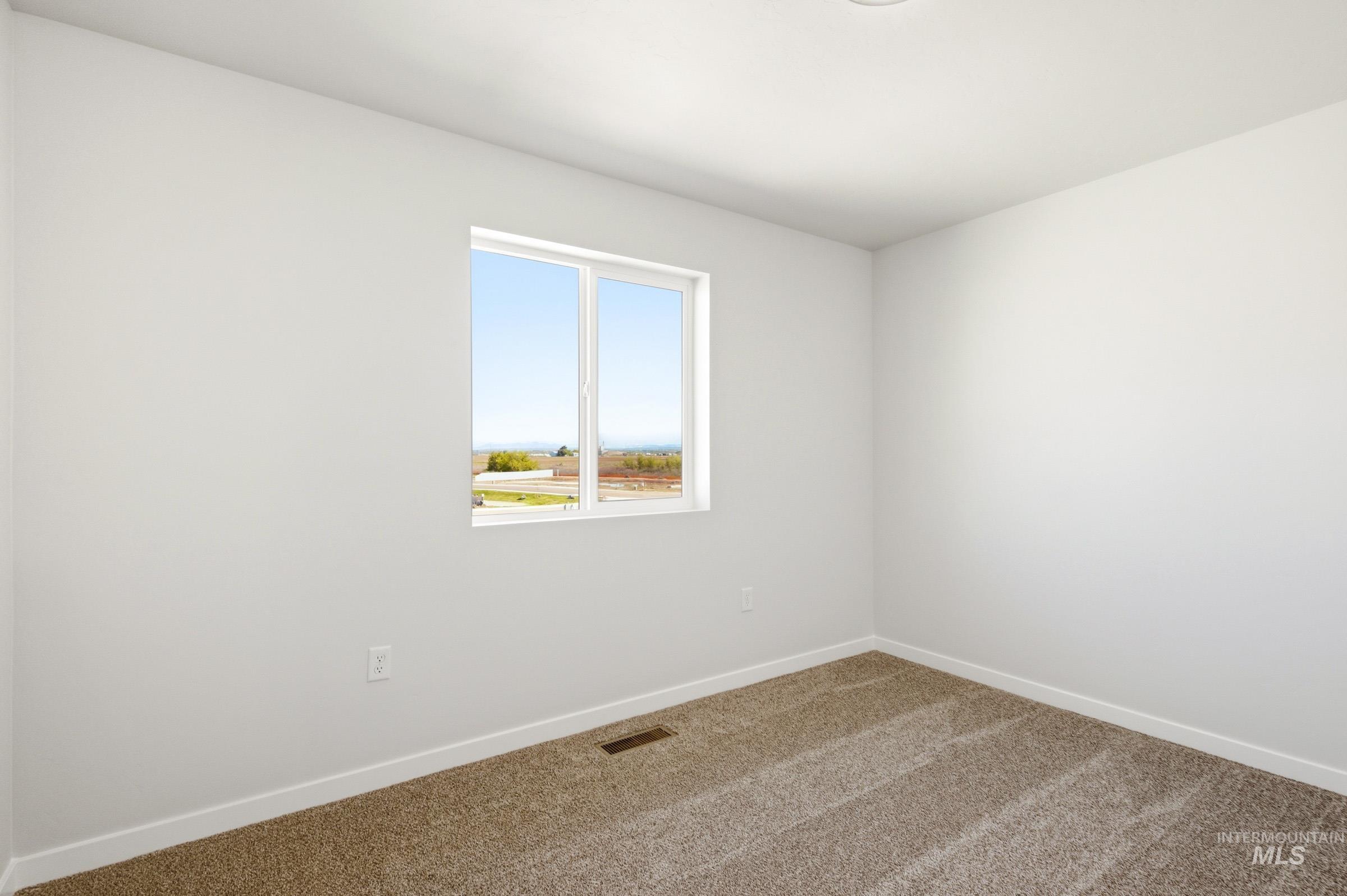 10794 Rutland Street Caldwell, ID 83605 - Photo 15 of 22 Bright room featuring neutral-toned carpet flooring, white walls, and a recessed ceiling light