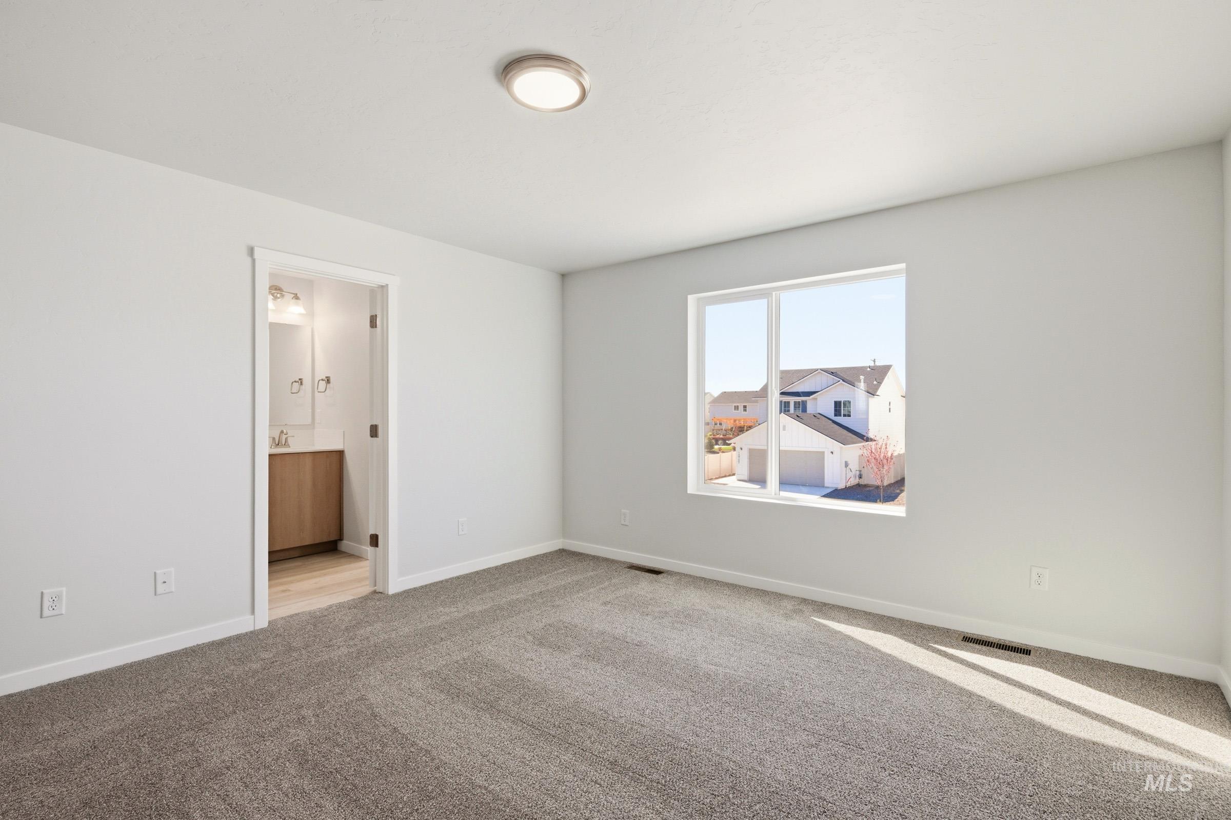 10794 Rutland Street Caldwell, ID 83605 - Photo 18 of 22 Carpeted room with a flush-mount ceiling light and a large window