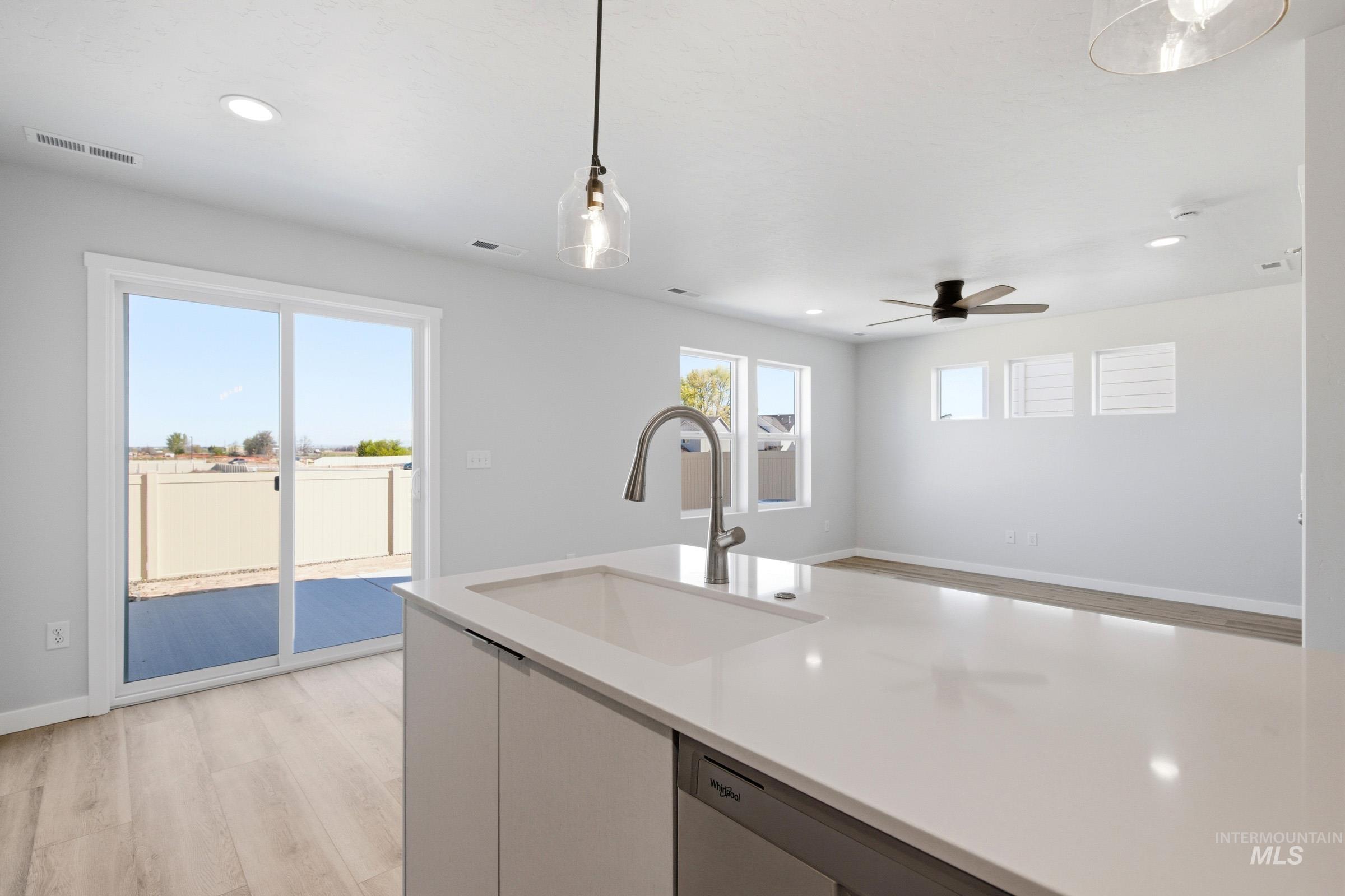 10794 Rutland Street Caldwell, ID 83605 - Photo 6 of 22 Modern kitchen island featuring a deep single-basin sink, gooseneck faucet, and integrated dishwasher