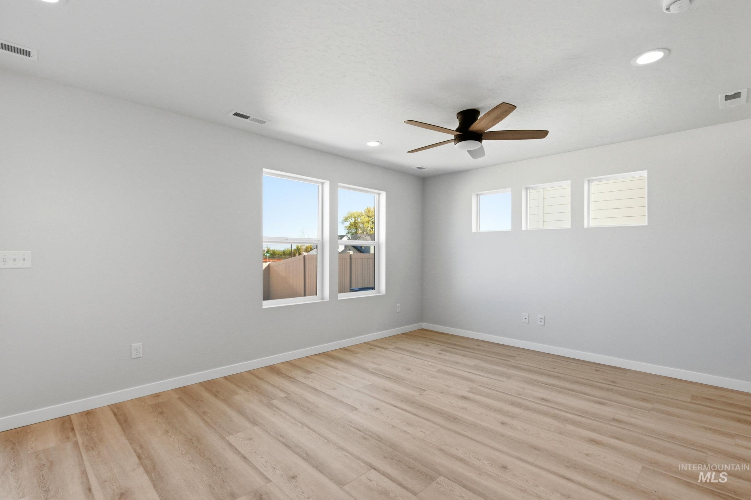 10794 Rutland Street Caldwell, ID 83605 - Photo 10 of 22 Spacious room featuring light wood-finish flooring, recessed lighting, and a ceiling fan