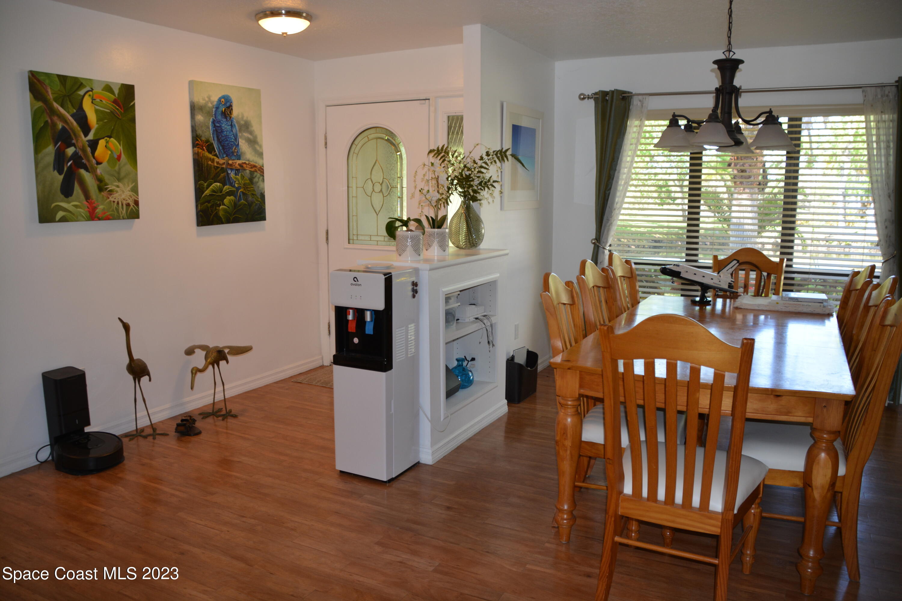 1045 Pine Island Road Merritt Island, FL 32953 - Photo 4 of 42 a view of a dining room with furniture window and wooden floor