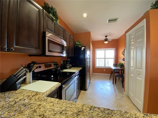 a kitchen with a stove a sink and a microwave