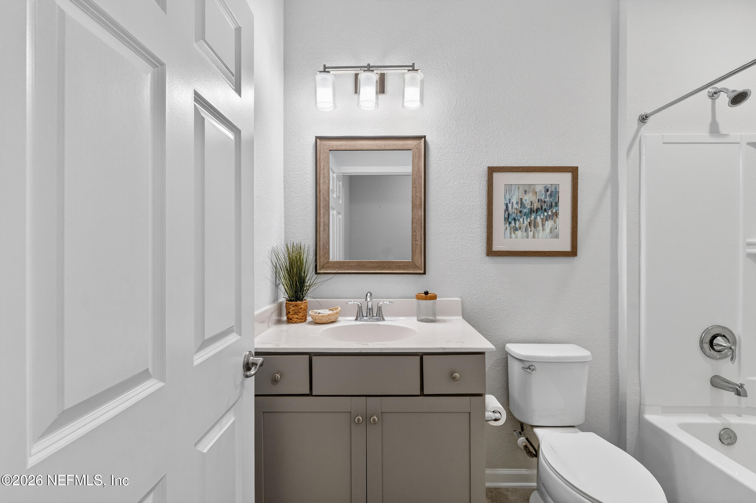 103 Ferndale Way St. Augustine, FL 32092 - Photo 14 of 54 a bathroom with a toilet sink vanity and mirror