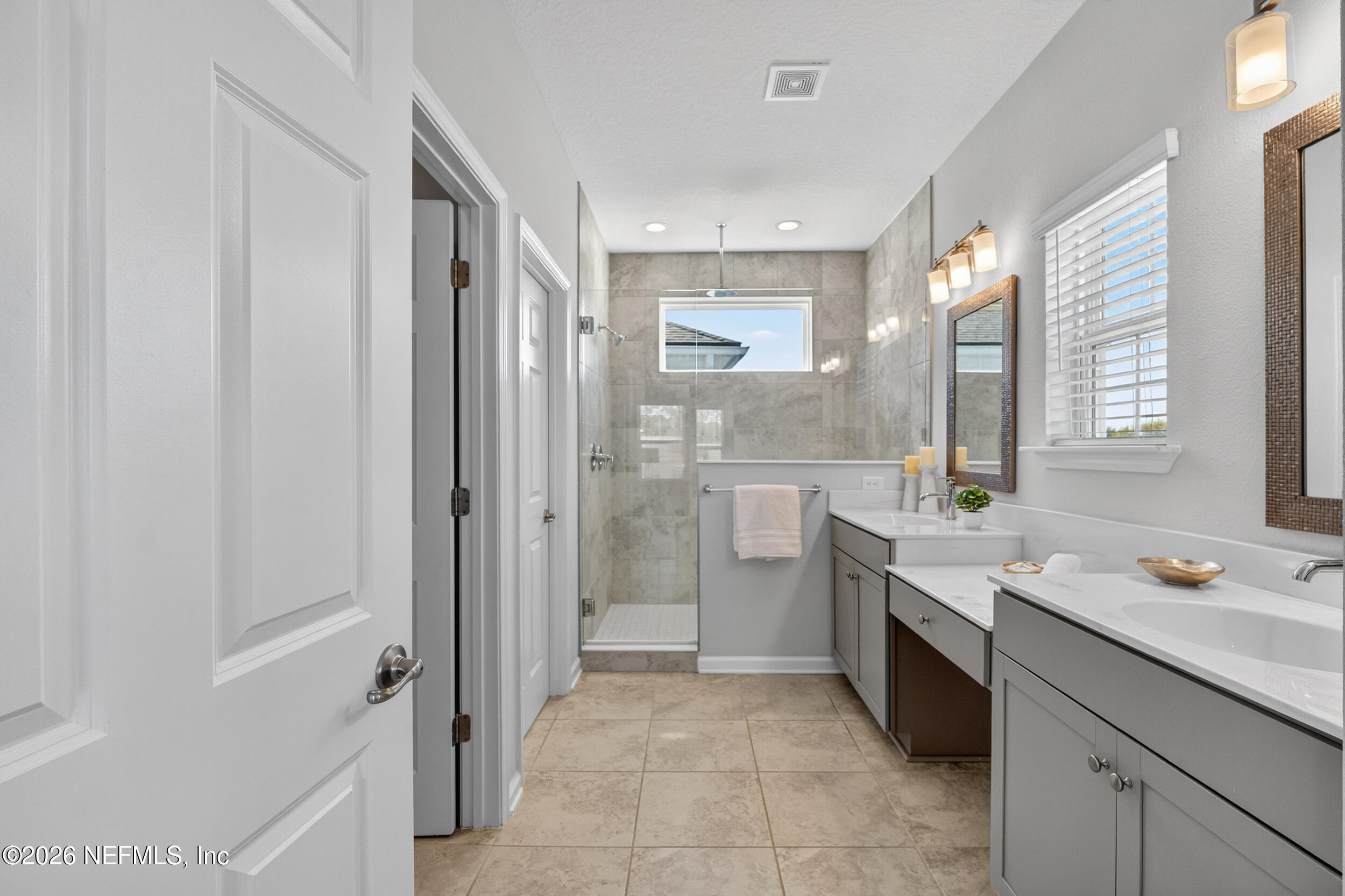 103 Ferndale Way St. Augustine, FL 32092 - Photo 24 of 54 a bathroom with a granite countertop sink a mirror and a bathtub
