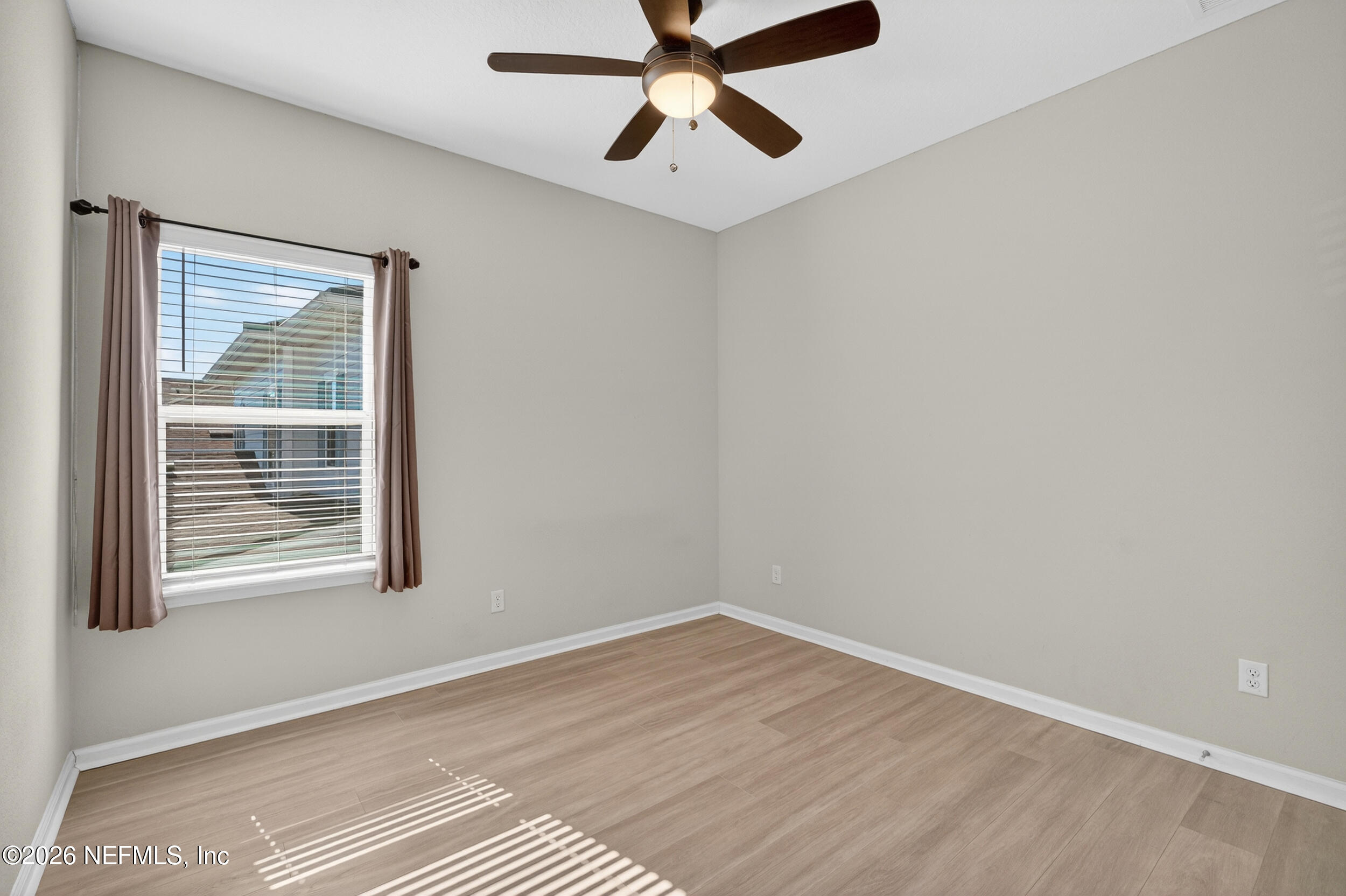 103 Ferndale Way St. Augustine, FL 32092 - Photo 29 of 54 a view of an empty room with wooden floor and a window