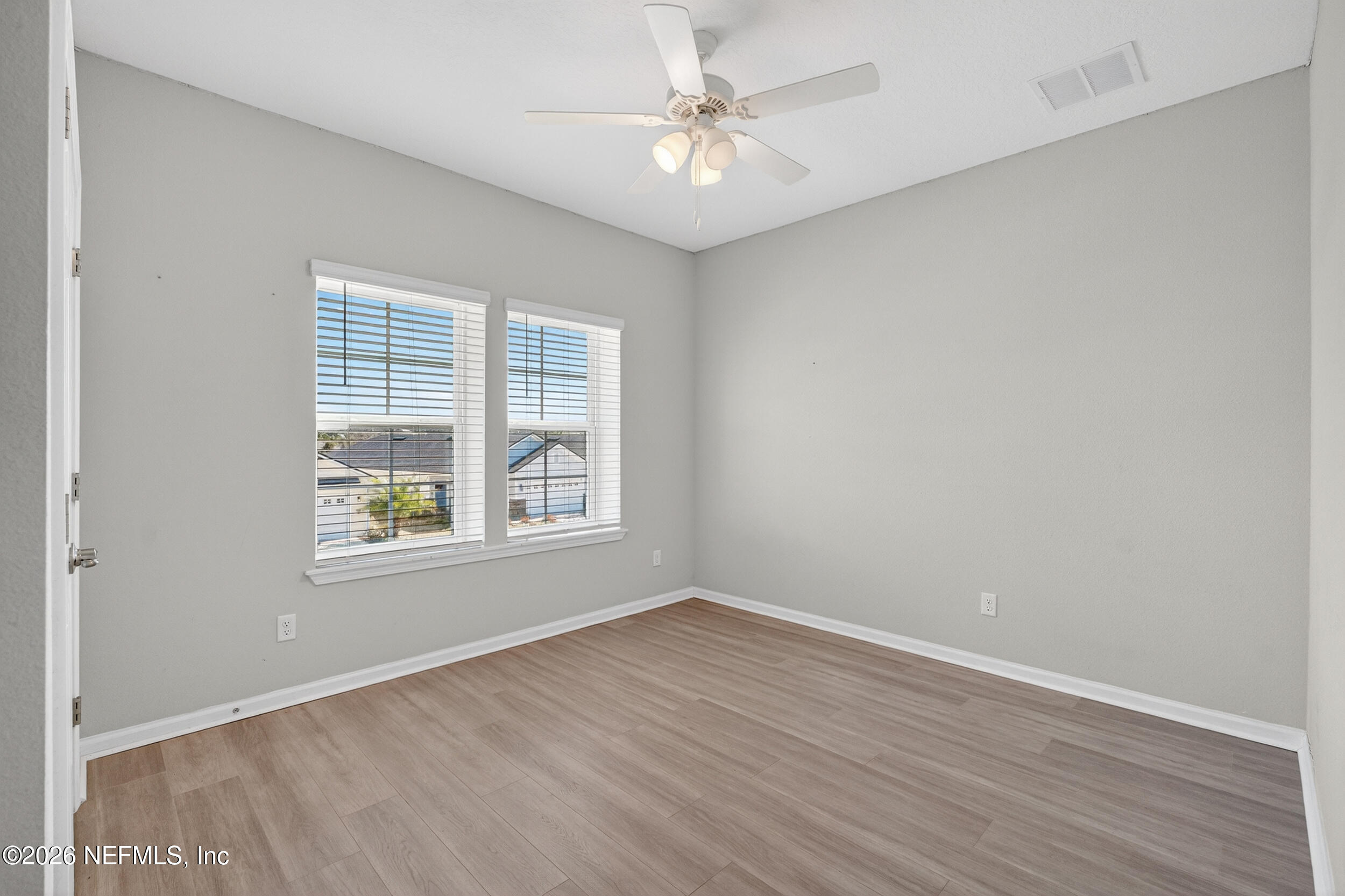 103 Ferndale Way St. Augustine, FL 32092 - Photo 31 of 54 an empty room with wooden floor and windows