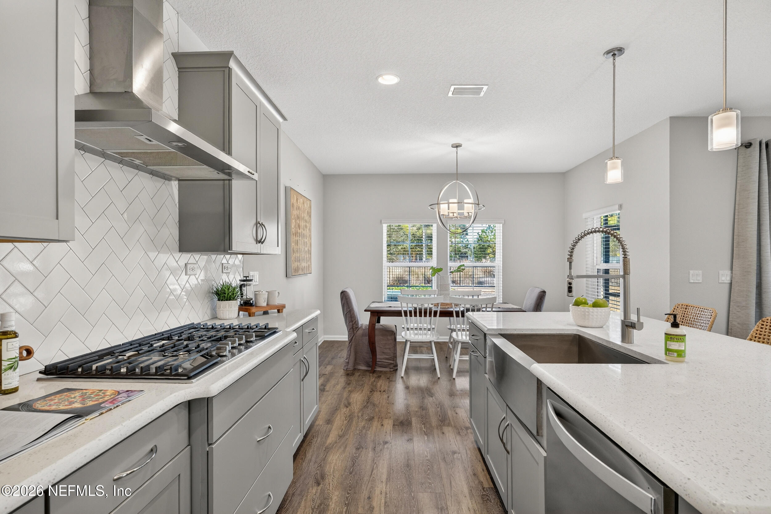 103 Ferndale Way St. Augustine, FL 32092 - Photo 6 of 54 a kitchen with a stove a sink a center island and windows