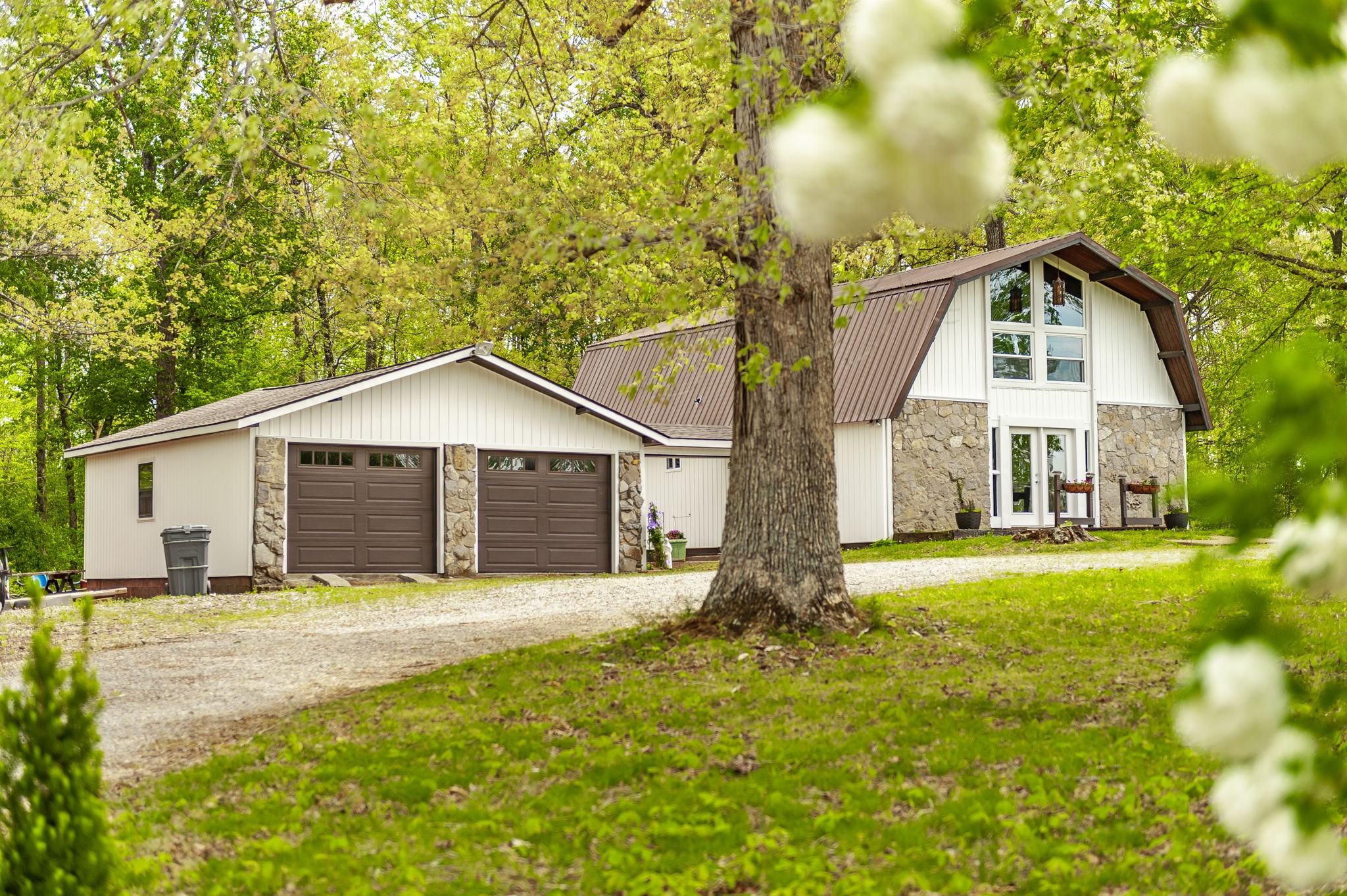 a front view of a house with yard and green space