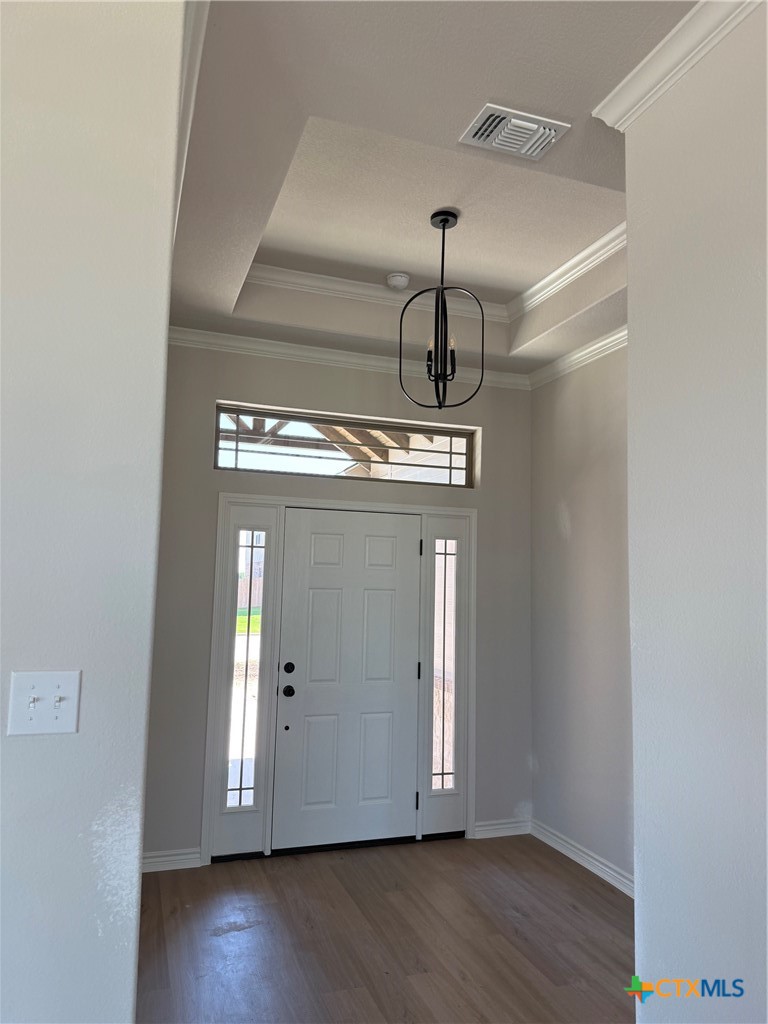 7102 Touchstone Drive Temple, TX 76502 - Photo 4 of 14 a view of a room with wooden floor chandelier and a window