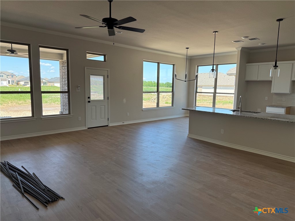 7102 Touchstone Drive Temple, TX 76502 - Photo 6 of 14 an empty room with wooden floor and windows
