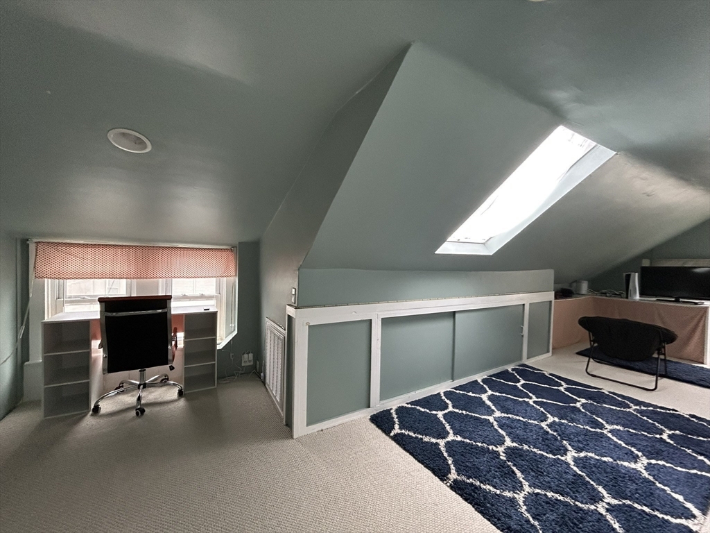 32 Parker Street, Unit 1 Lexington, MA 02421 - Photo 15 of 20 a bedroom with furniture and a flat screen tv