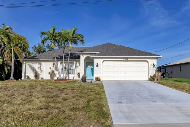 a view of a house with a yard and garage