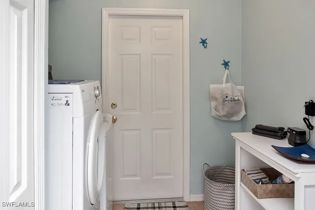 a room with a door open a kitchen