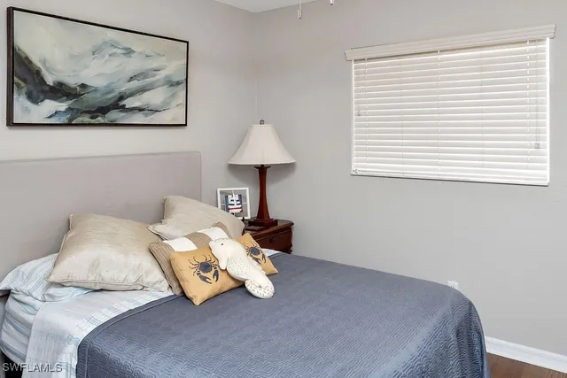 a bedroom with a bed and a painting on the wall