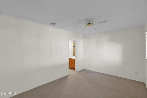 an empty room with a glass door shower and a sink