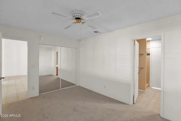 a view of a backyard with wooden fence and floor