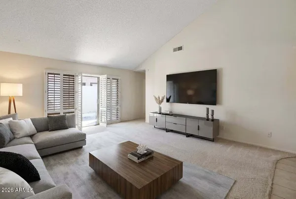a living room with furniture and a flat screen tv