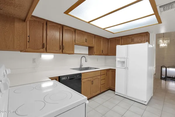 a kitchen with a sink a refrigerator and cabinets