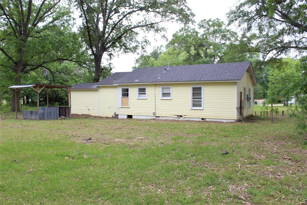 929 Forsythe Street Carthage, TX 75633 - Photo 3 of 9 Back of property featuring a lawn