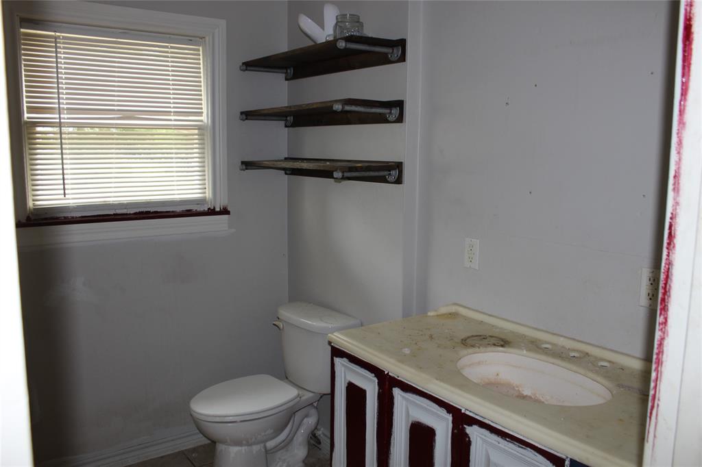 929 Forsythe Street Carthage, TX 75633 - Photo 6 of 9 Bathroom featuring toilet and vanity