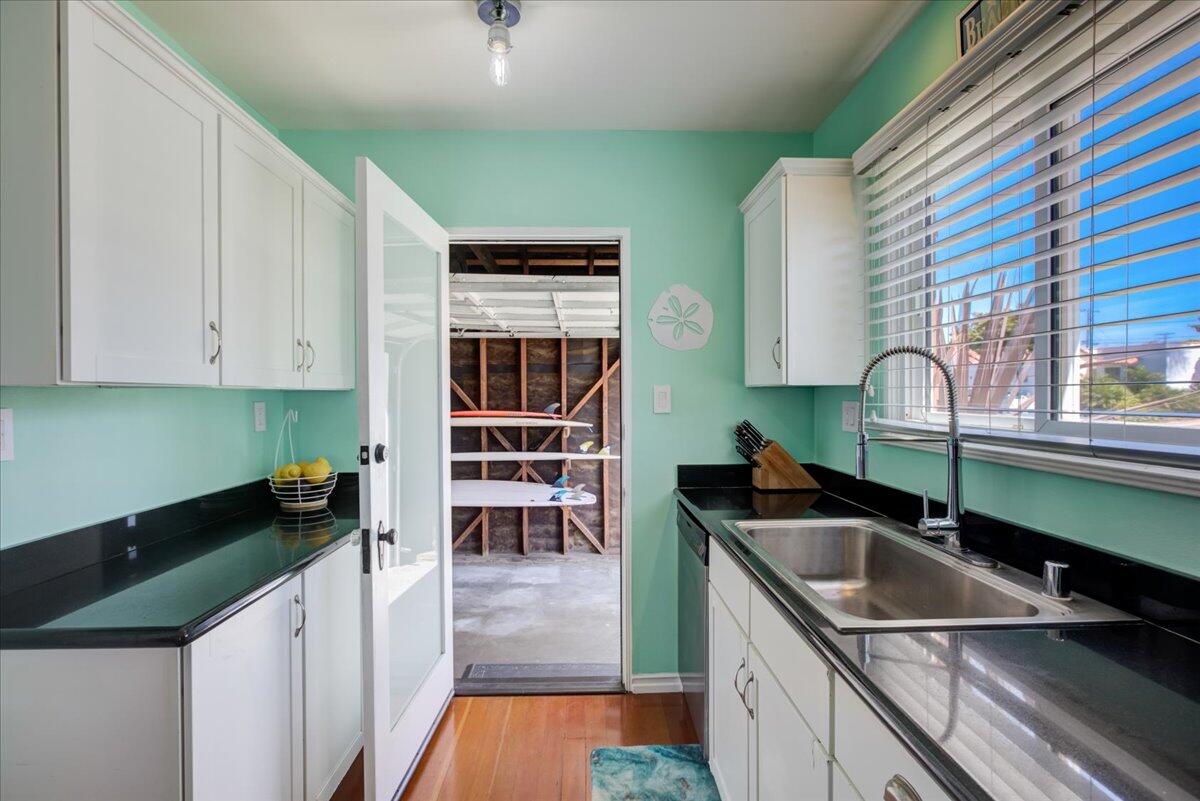 425 Howard Street Ventura, CA 93003 - Photo 14 of 31 a kitchen with granite countertop a sink a stove and cabinets