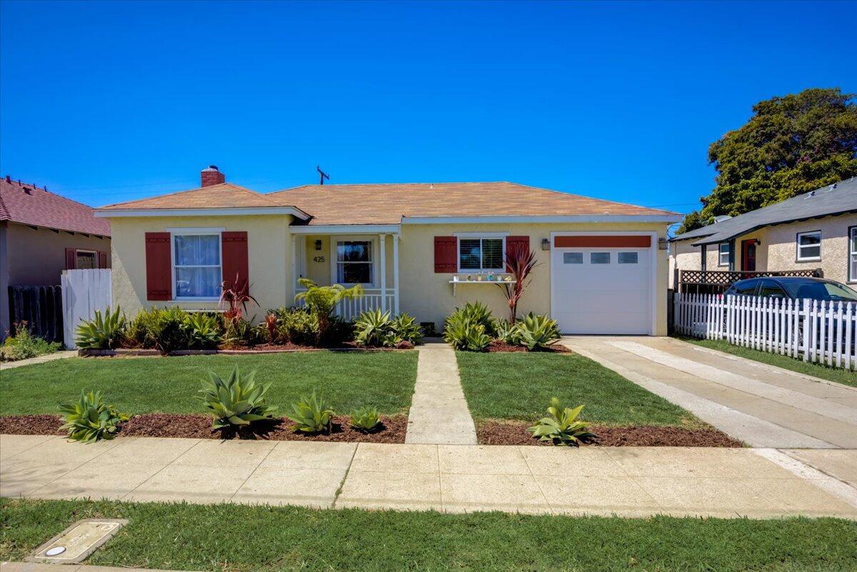 425 Howard Street Ventura, CA 93003 - Photo 2 of 31 a front view of a house with a garden