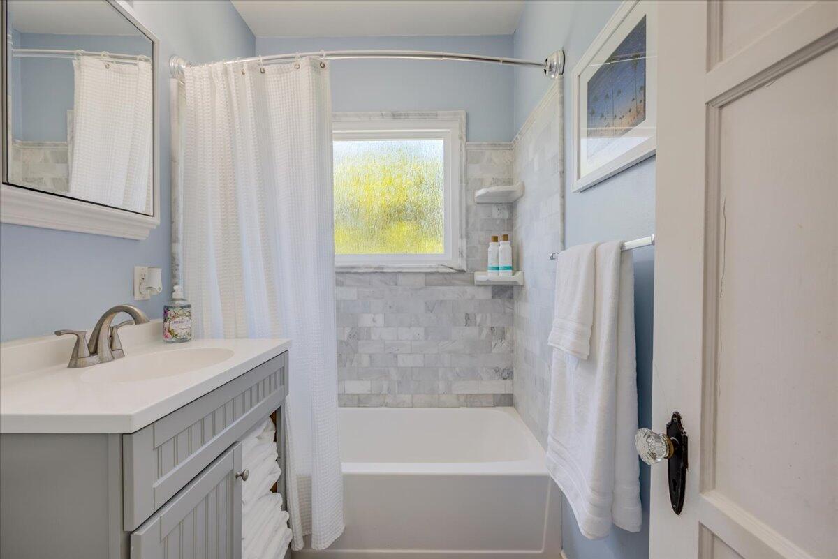 425 Howard Street Ventura, CA 93003 - Photo 21 of 31 a bathroom with a sink a bathtub and a window