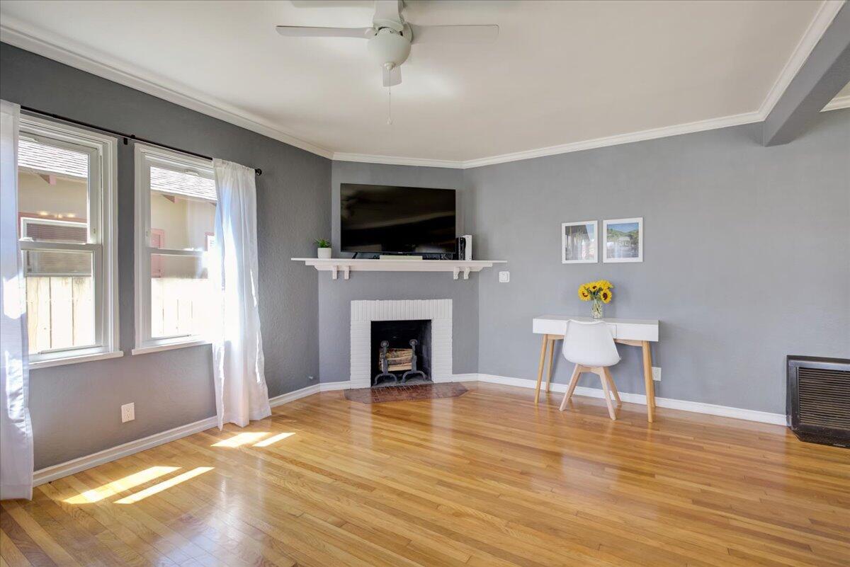 425 Howard Street Ventura, CA 93003 - Photo 9 of 31 a living room with furniture a fireplace and a flat screen tv