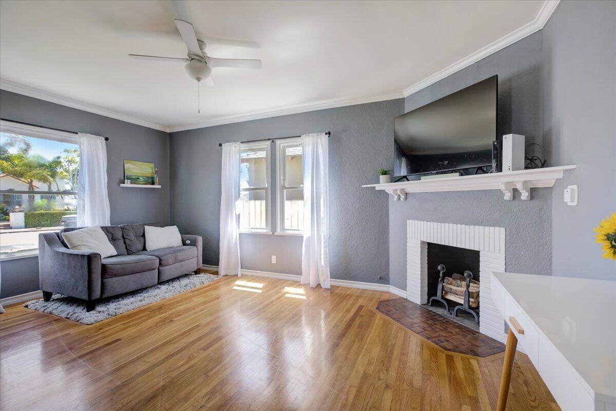 425 Howard Street Ventura, CA 93003 - Photo 10 of 31 a living room with furniture a flat screen tv and a fireplace