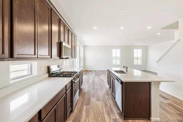 a view of a hallway with wooden floor and entryway