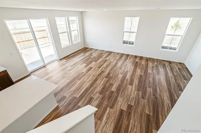a view of an empty room with closet and a window