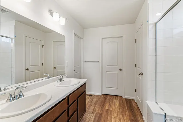 a bathroom with a sink double vanity and a mirror