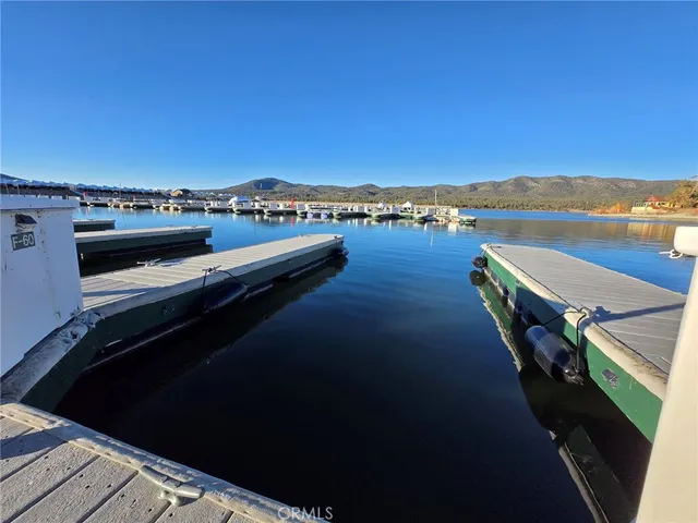 a view of a balcony with wooden floor and lake view