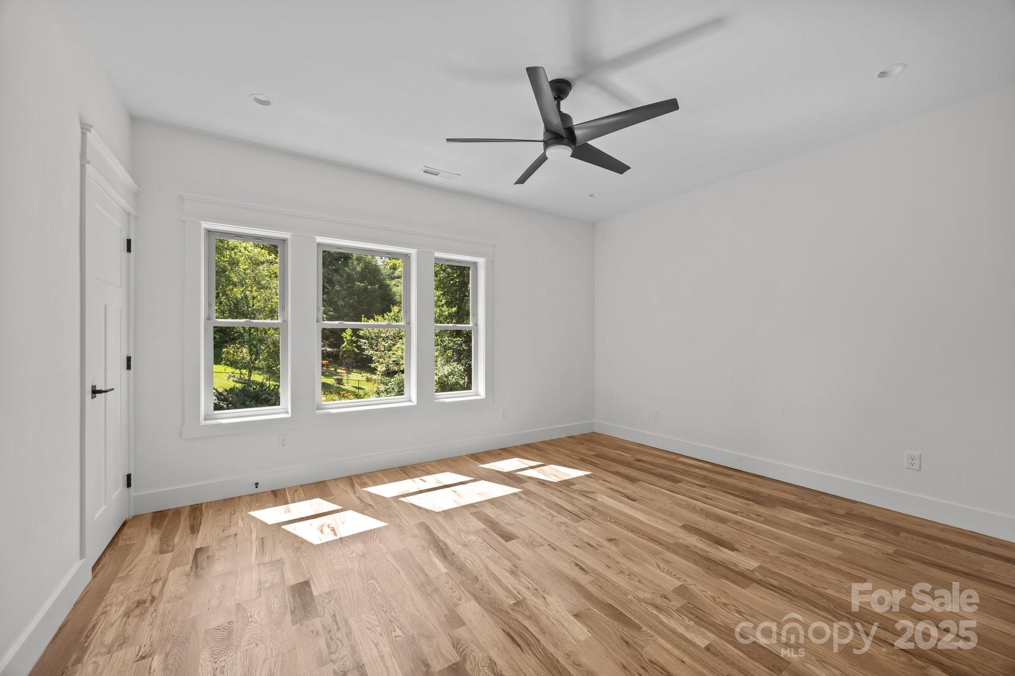58 Pinedale Road Asheville, NC 28805 - Photo 18 of 24 a view of empty room with wooden floor and fan
