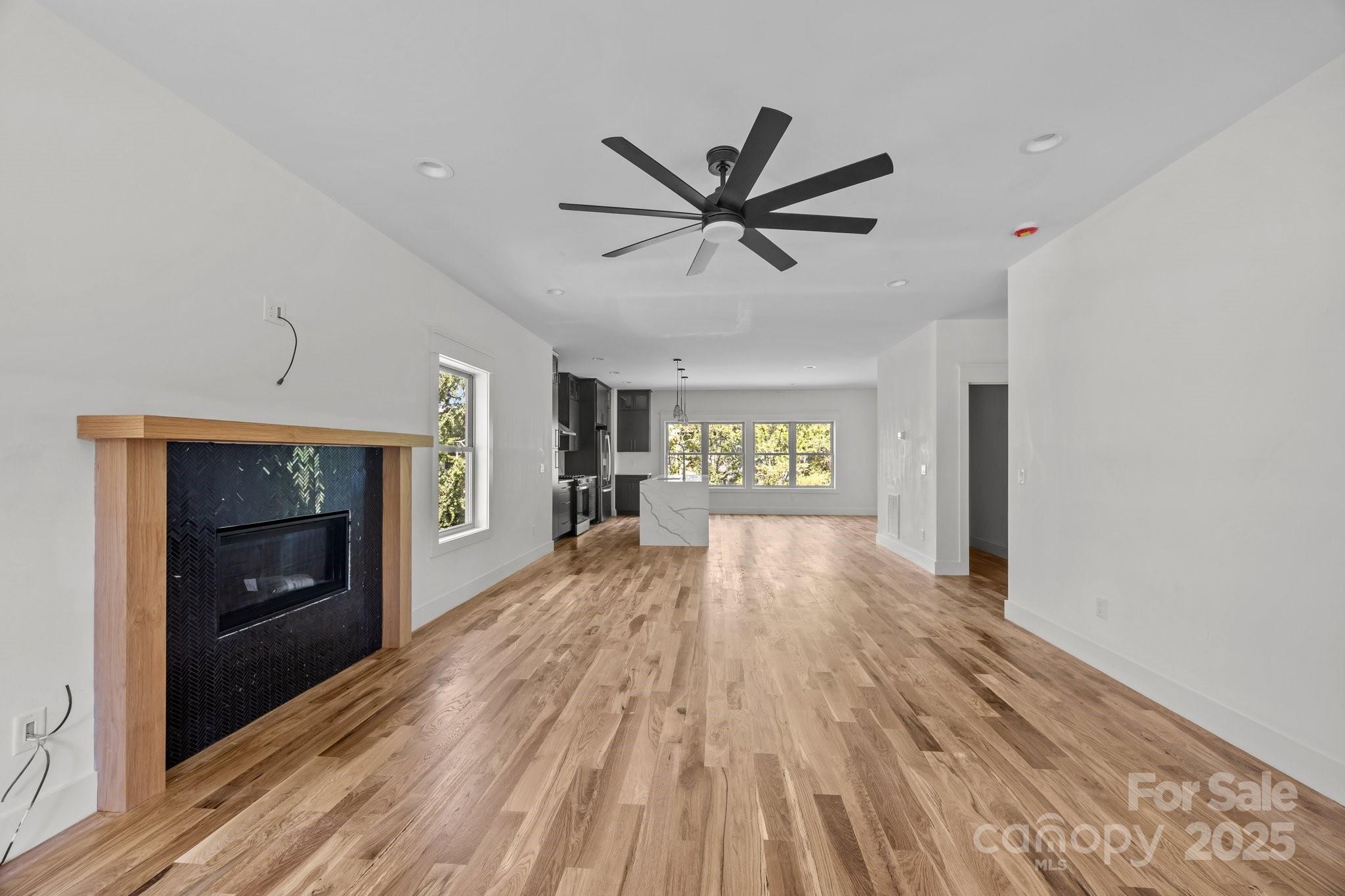 58 Pinedale Road Asheville, NC 28805 - Photo 4 of 24 a view of a livingroom with a fireplace a ceiling fan and wooden floor