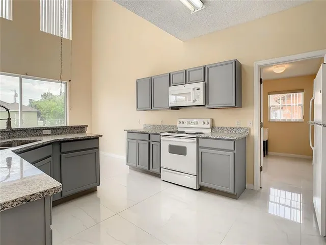 a kitchen with stainless steel appliances granite countertop a sink and a cabinets