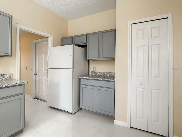 a view of a kitchen with furniture and an empty room