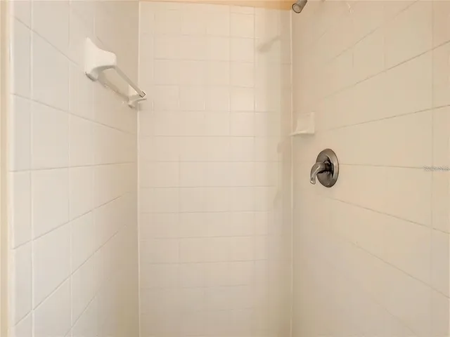 a bathroom with a tub a sink and a shower