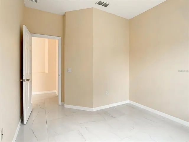 a bathroom with a granite countertop shower sink and mirror