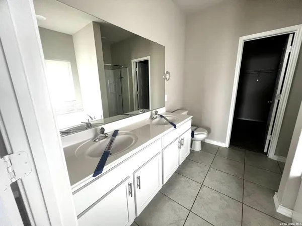a spacious bathroom with a bathtub sink and toilet