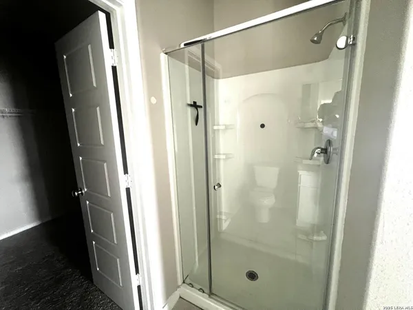 a bathroom with a glass shower door