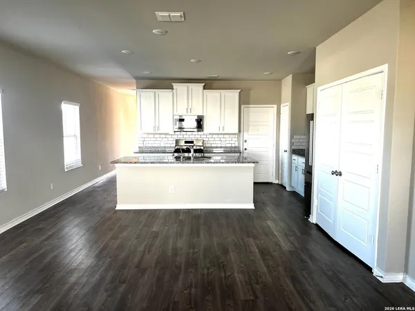 a large kitchen with stainless steel appliances a lot of counter space and a window