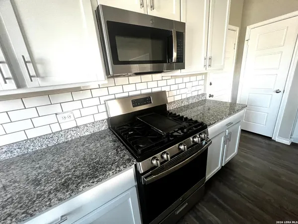 a kitchen with a stove and a microwave