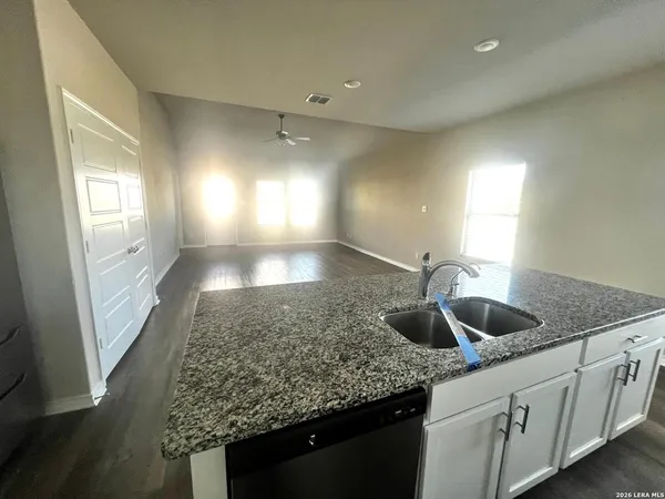 a kitchen with granite countertop a sink and a window