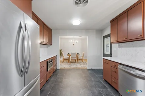 a kitchen with stainless steel appliances granite countertop a stove sink and cabinets