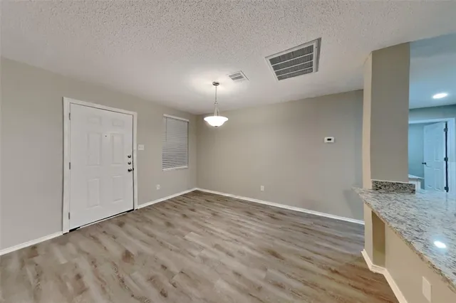a view of a kitchen cabinets and wooden floor
