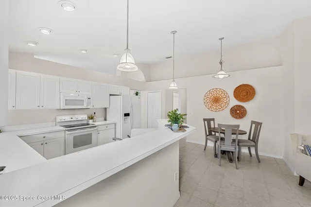 a large kitchen with a table and chairs
