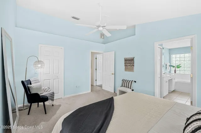a bedroom with a bed and a chair with the wooden floor